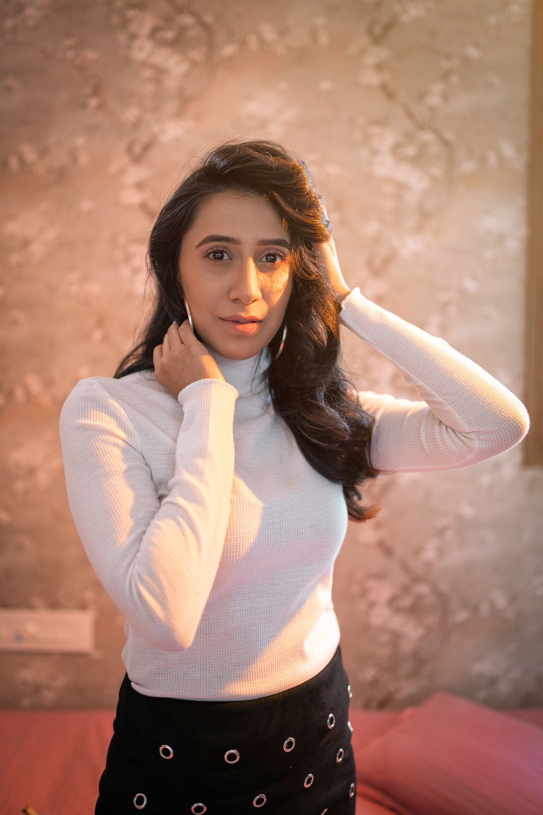 Suman — warm portrait, hand to face