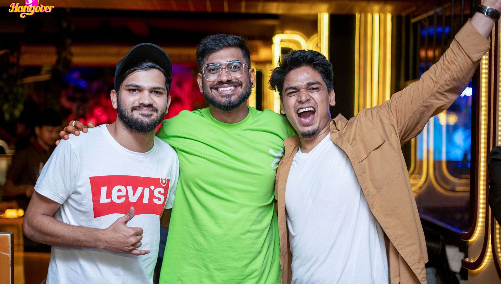 Night out — three friends, mid-laugh