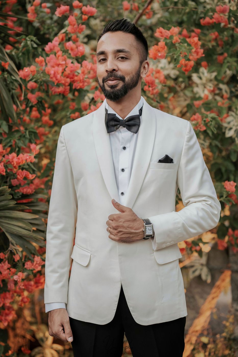 Groom portrait in a white tuxedo