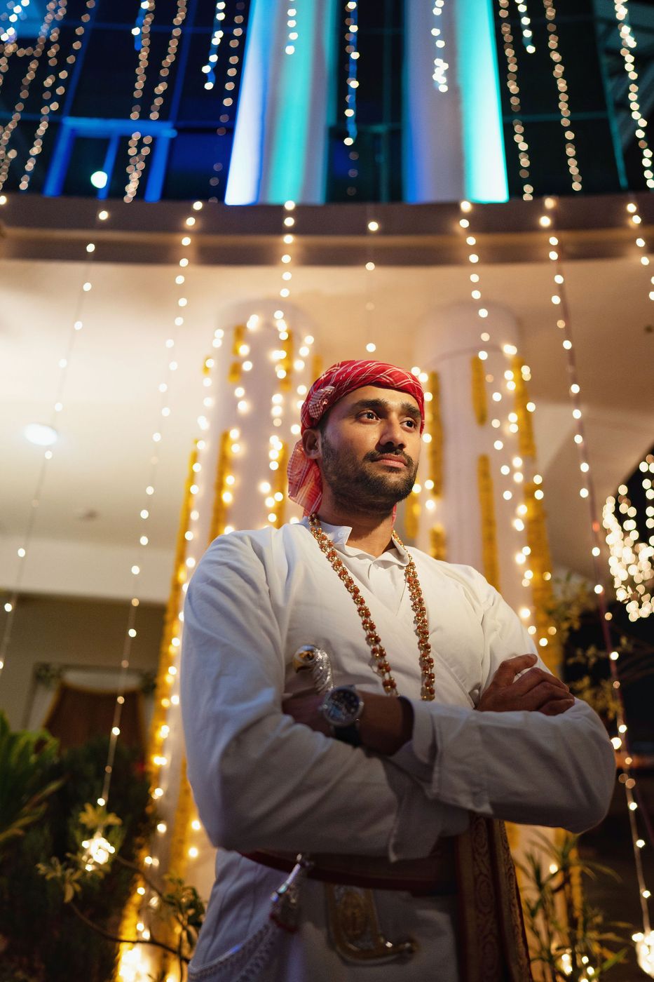 Groom framed by the fairy lights